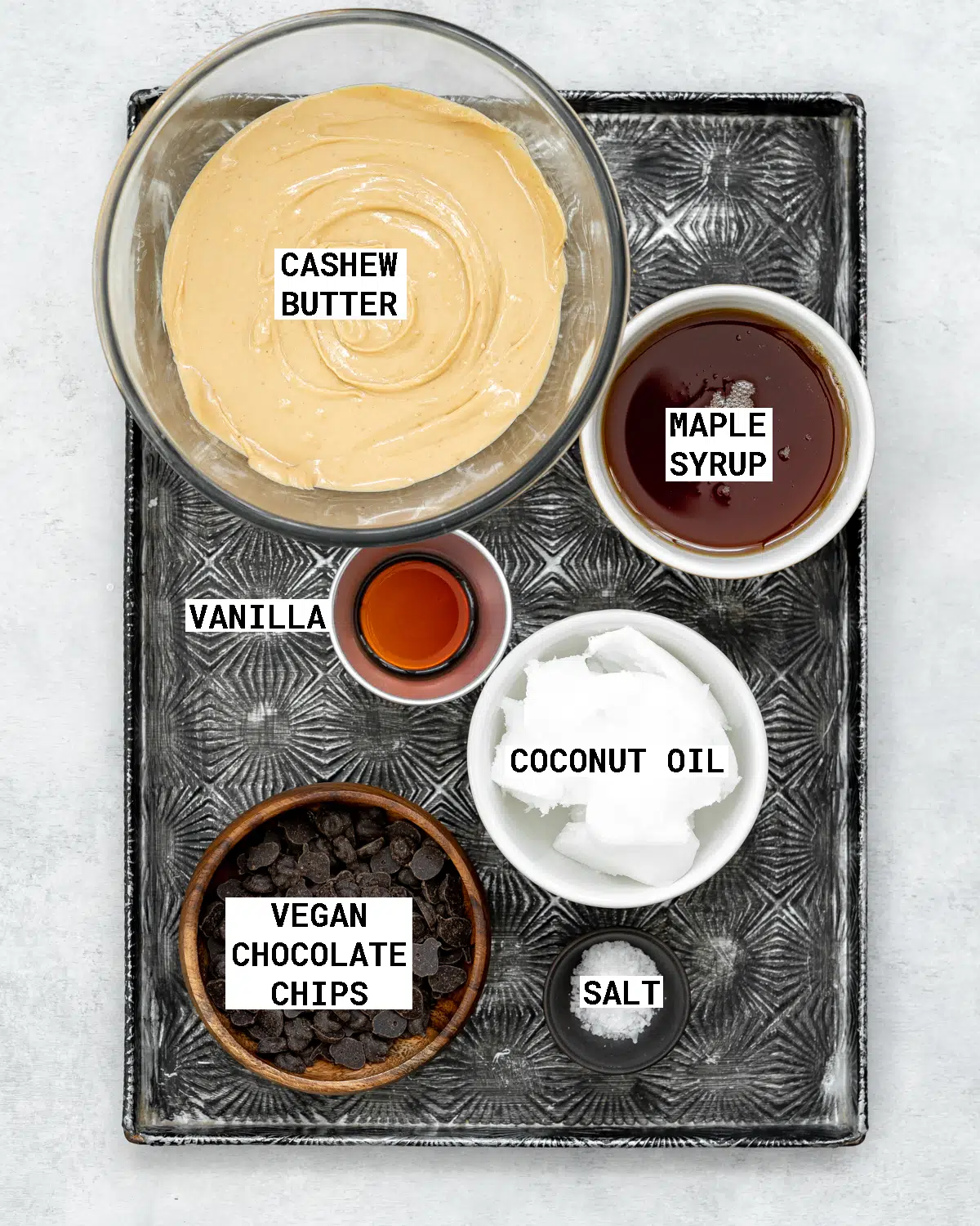 6 ingredients to make cookie dough fudge on a tray.