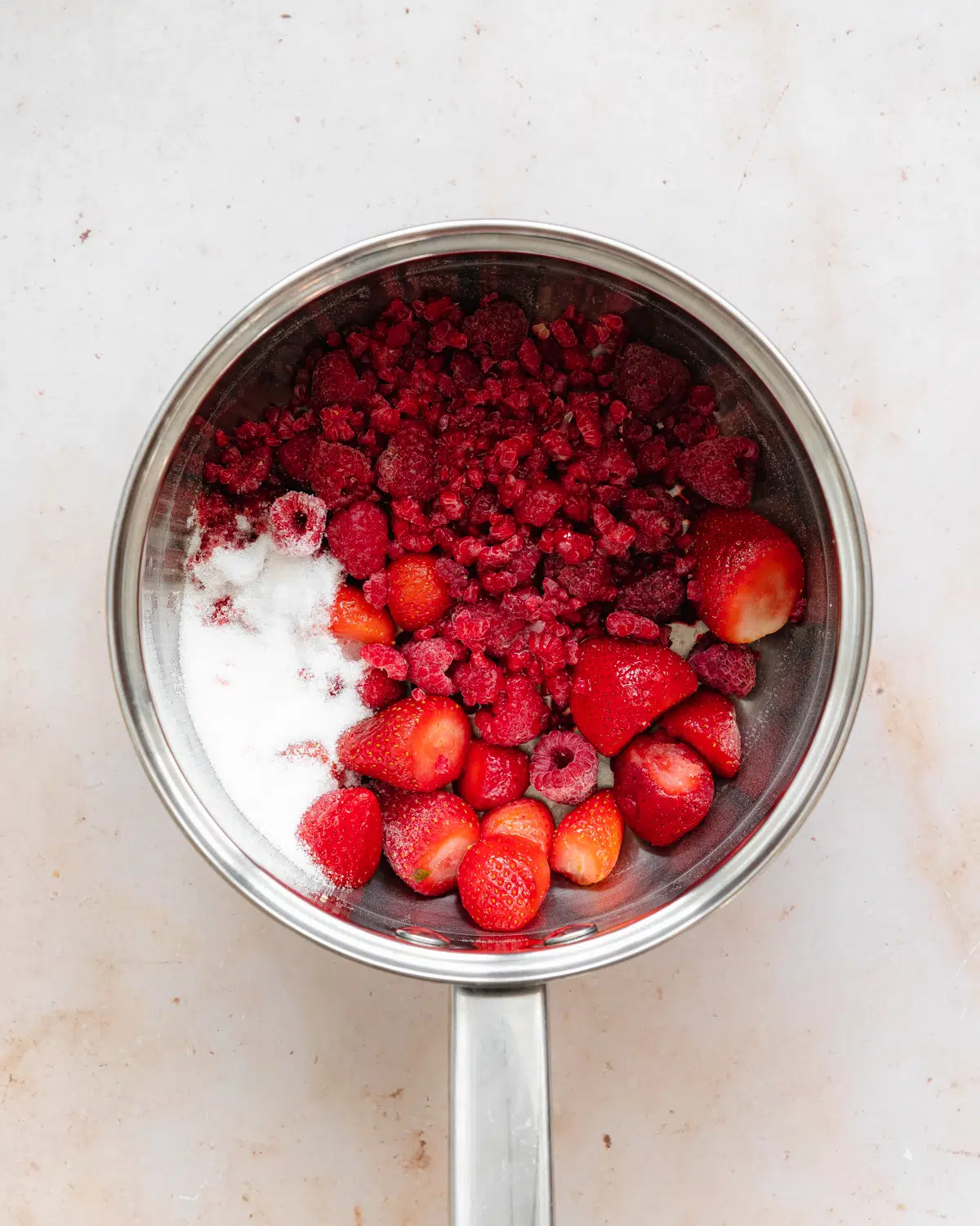 berries and sugar in a saucepan.