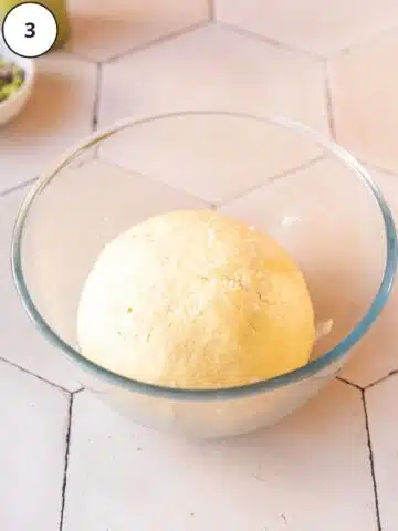 proved vegan doughnut dough in a greased bowl.