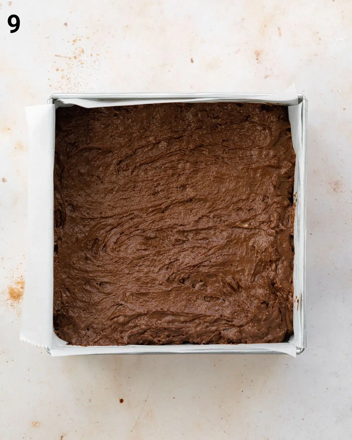 brownie batter in a square pan.