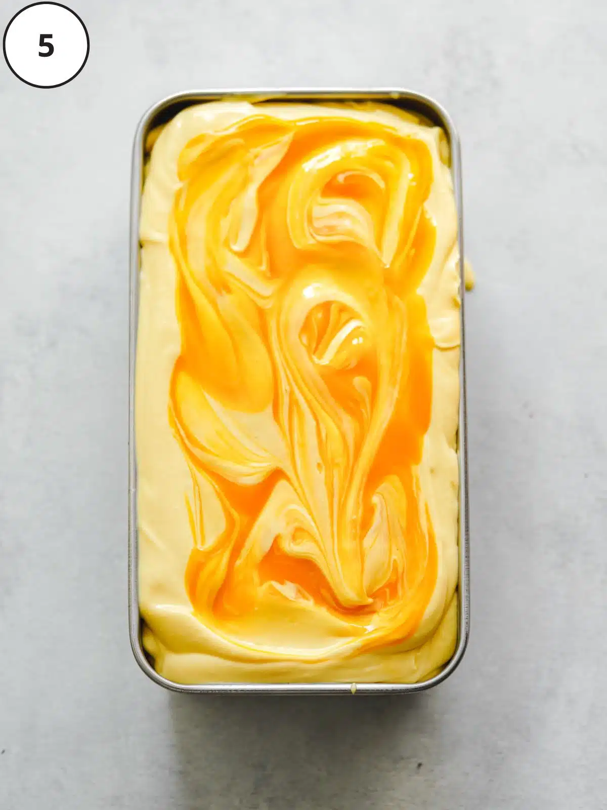 mango ice cream in a metal container.