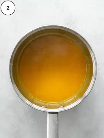 passion fruit puree reduced down into a thick syrup in a saucepan.