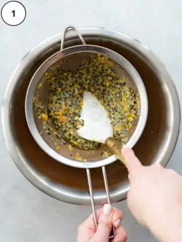 separating passion fruit pulp from the seeds by squeezing it through a sieve with a spatula.
