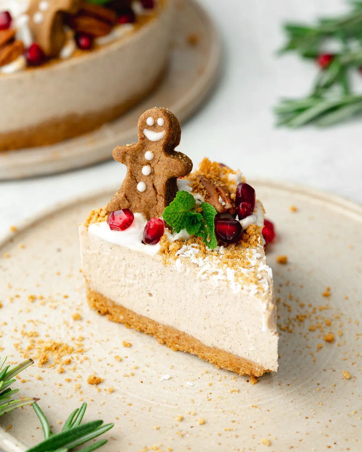 slice of festive cheesecake with gingerbread man on top.