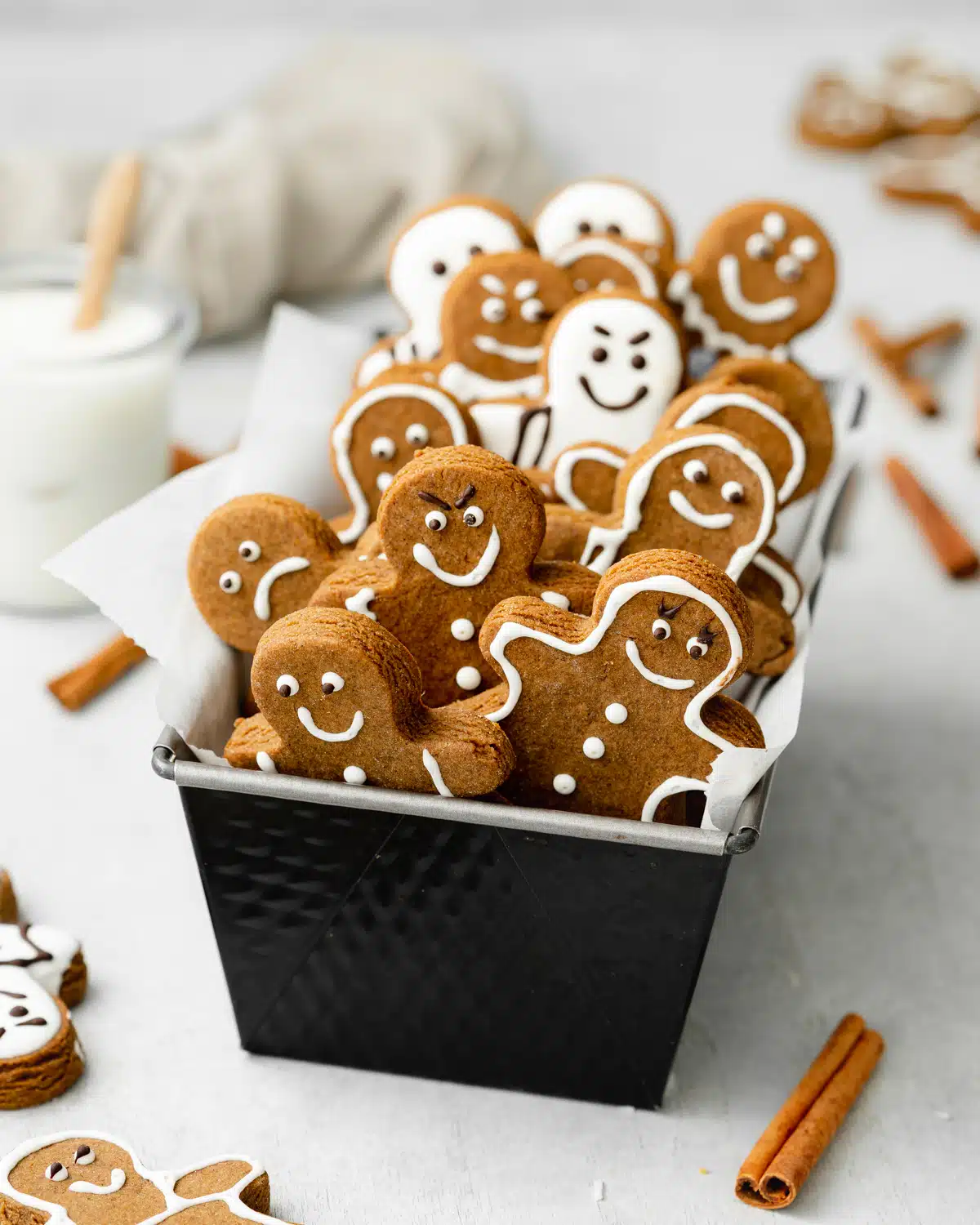 gingerbread men in a loaf pan on a grey surface.