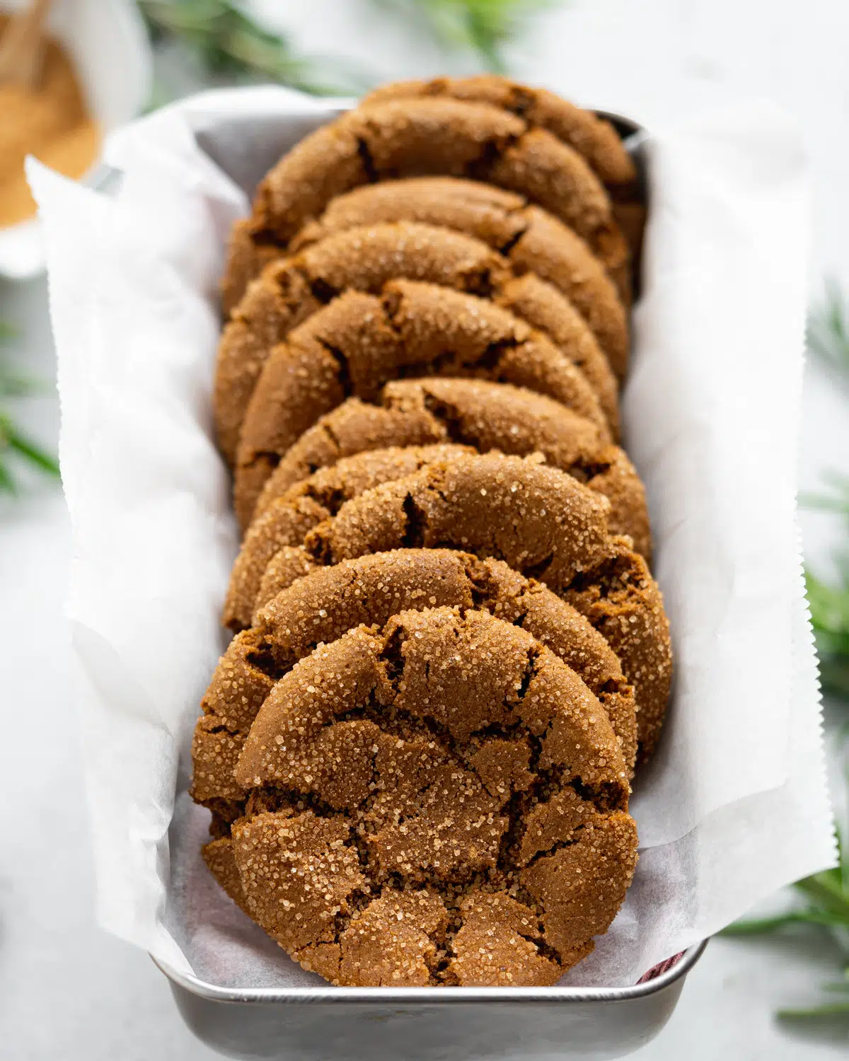 molasses crinkle cookies in a loaf tin with parchment paper.