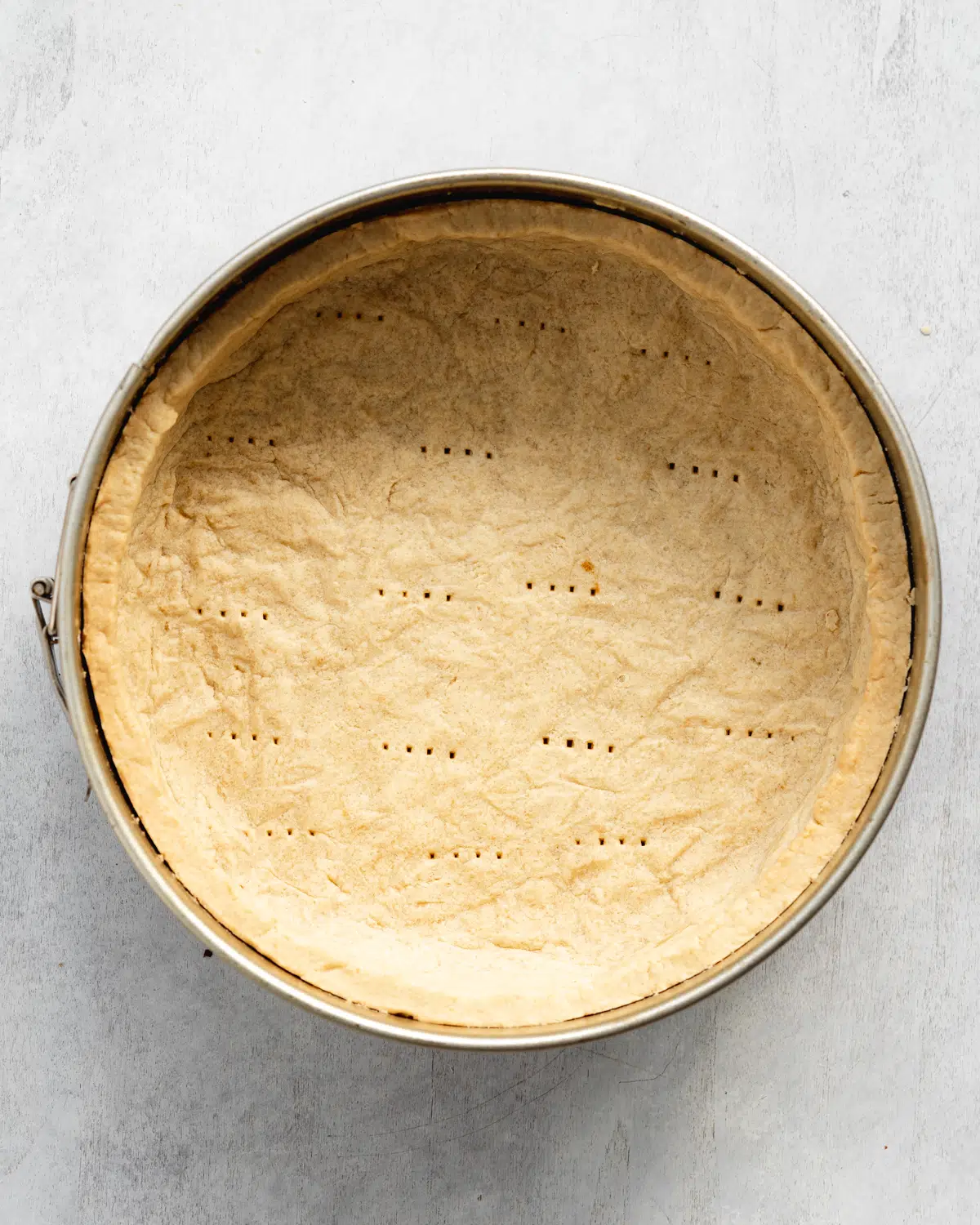 baked shortcrust pastry in a round cake tin.