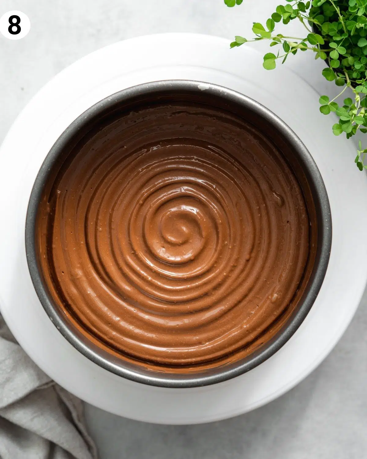 top down view of chocolate cheesecake with swirled topping.