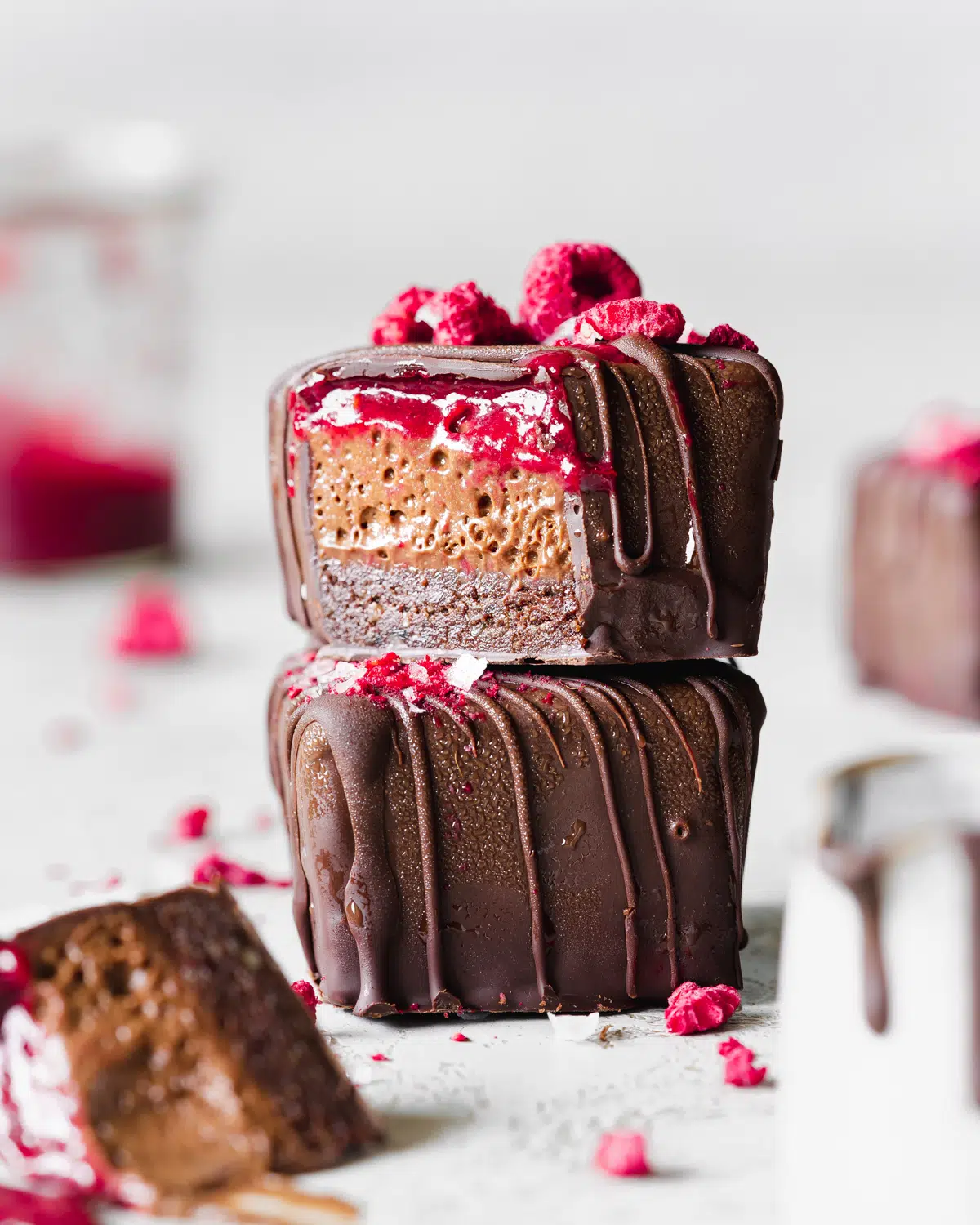 stack of chocolate covered brownies with chocolate mousse and raspberry jam centers.