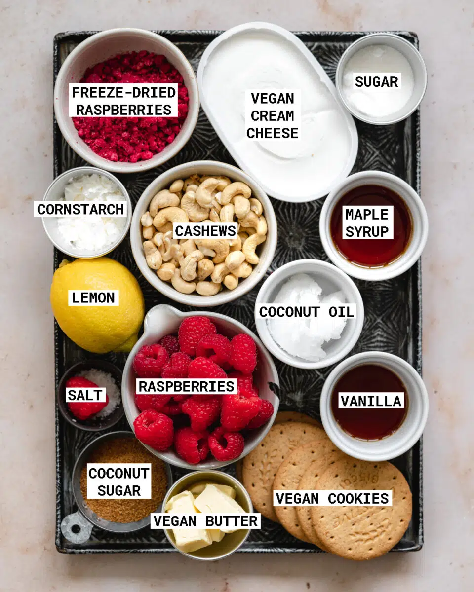 ingredients for vegan raspberry cheesecake measured out on a metal tray.