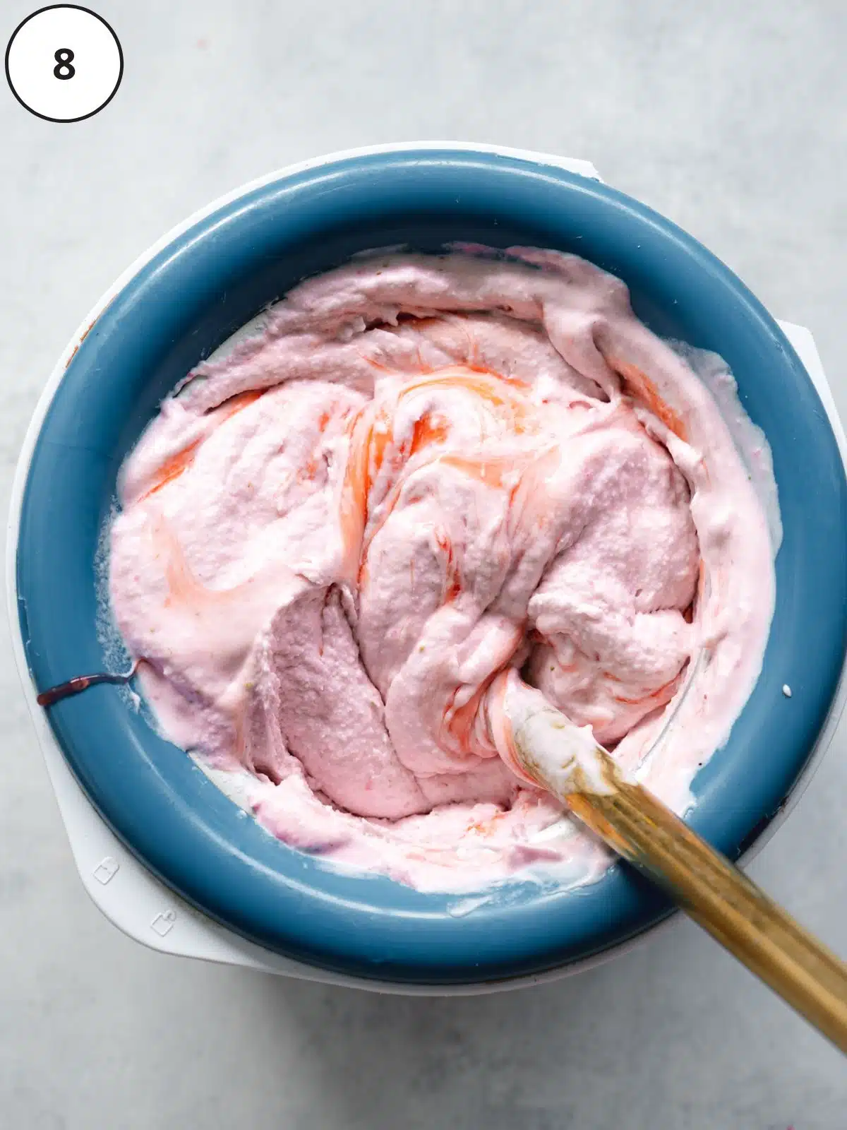 freshly churned vegan strawberry ice cream in an ice cream machine.