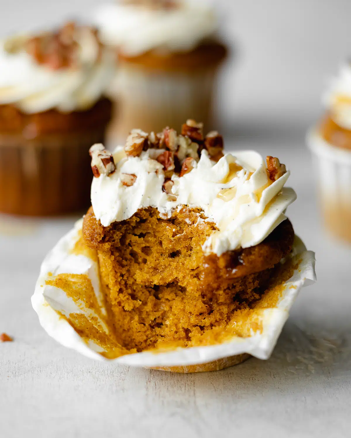pumpkin cupcake with a bite taken out of it.