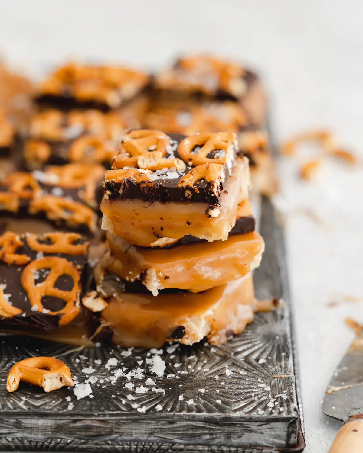 miso caramel millionaire shortbread bars stacked on top of each other.