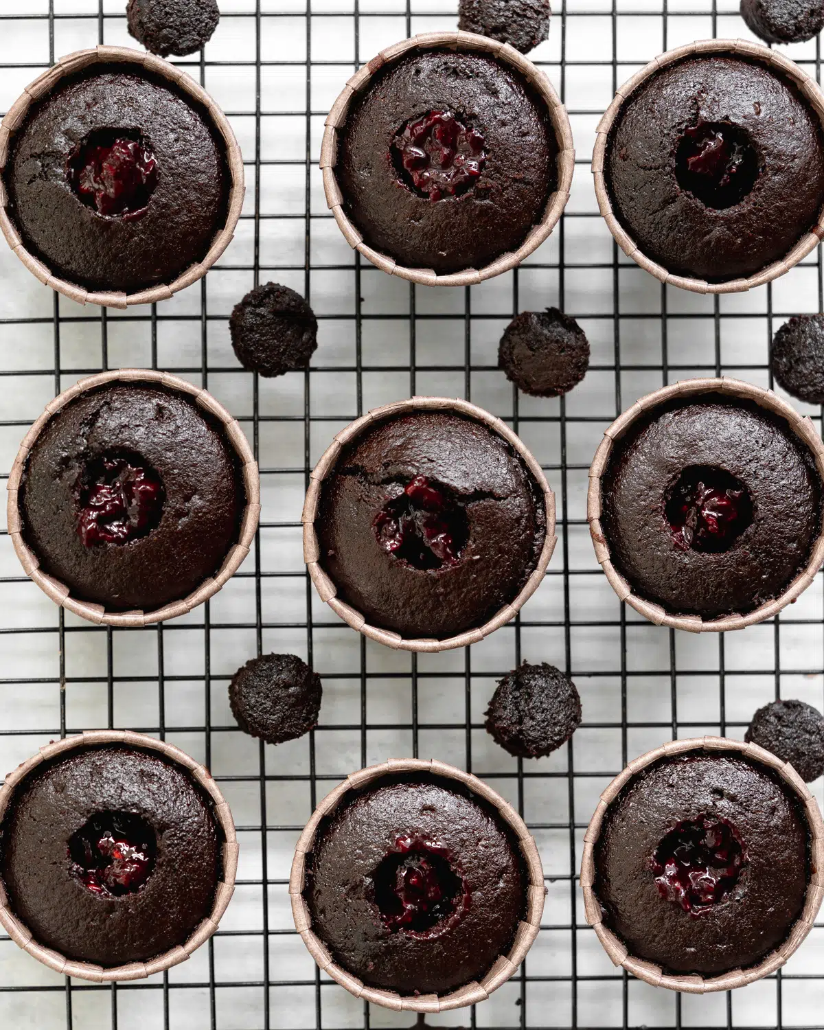 chocolate cupcakes willed with blackberry jam.