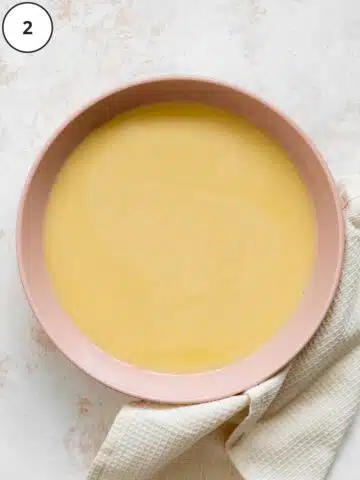 melted vegan white chocolate in a pink ceramic bowl.