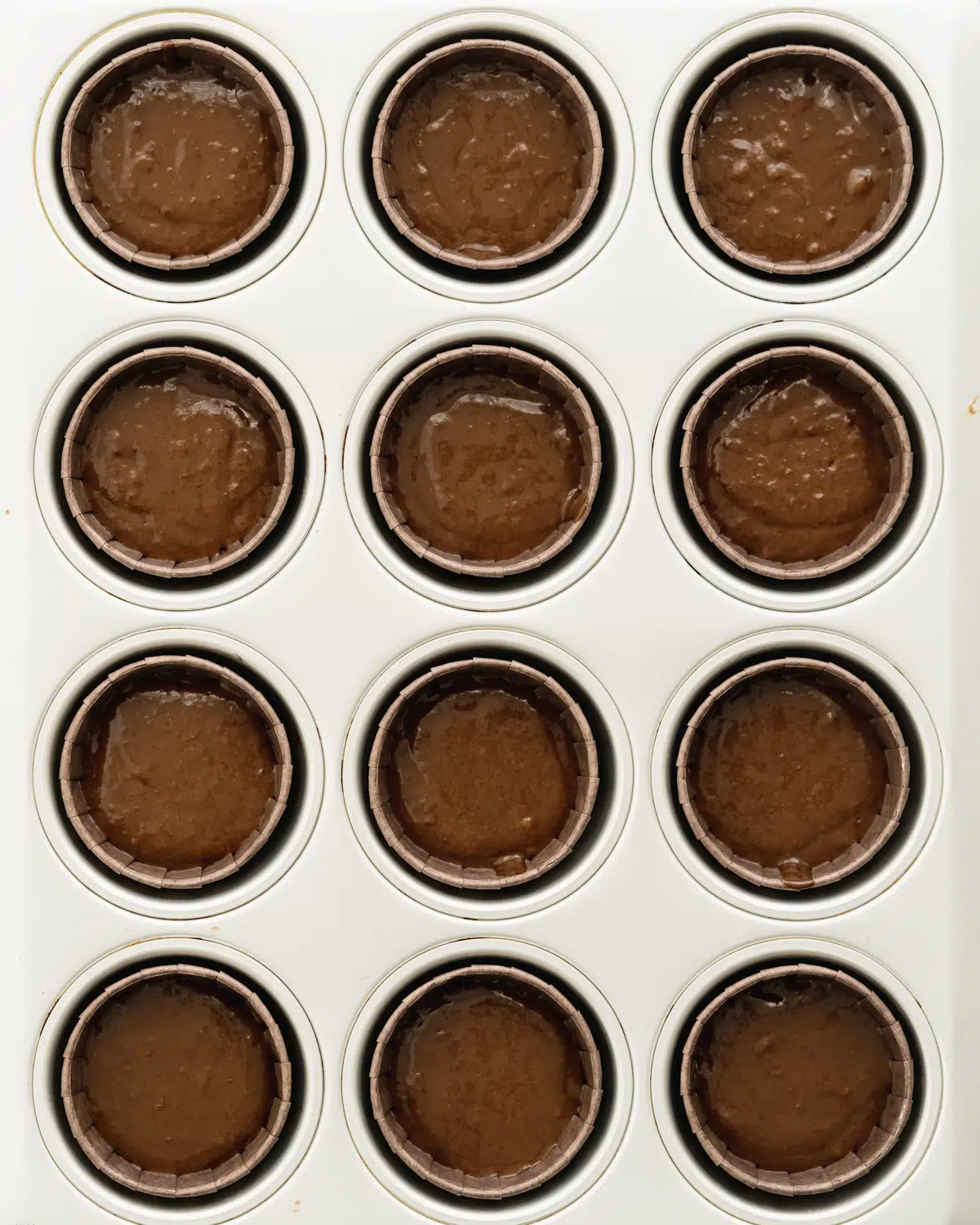 chocolate cupcakes in a baking tray ready for the oven.