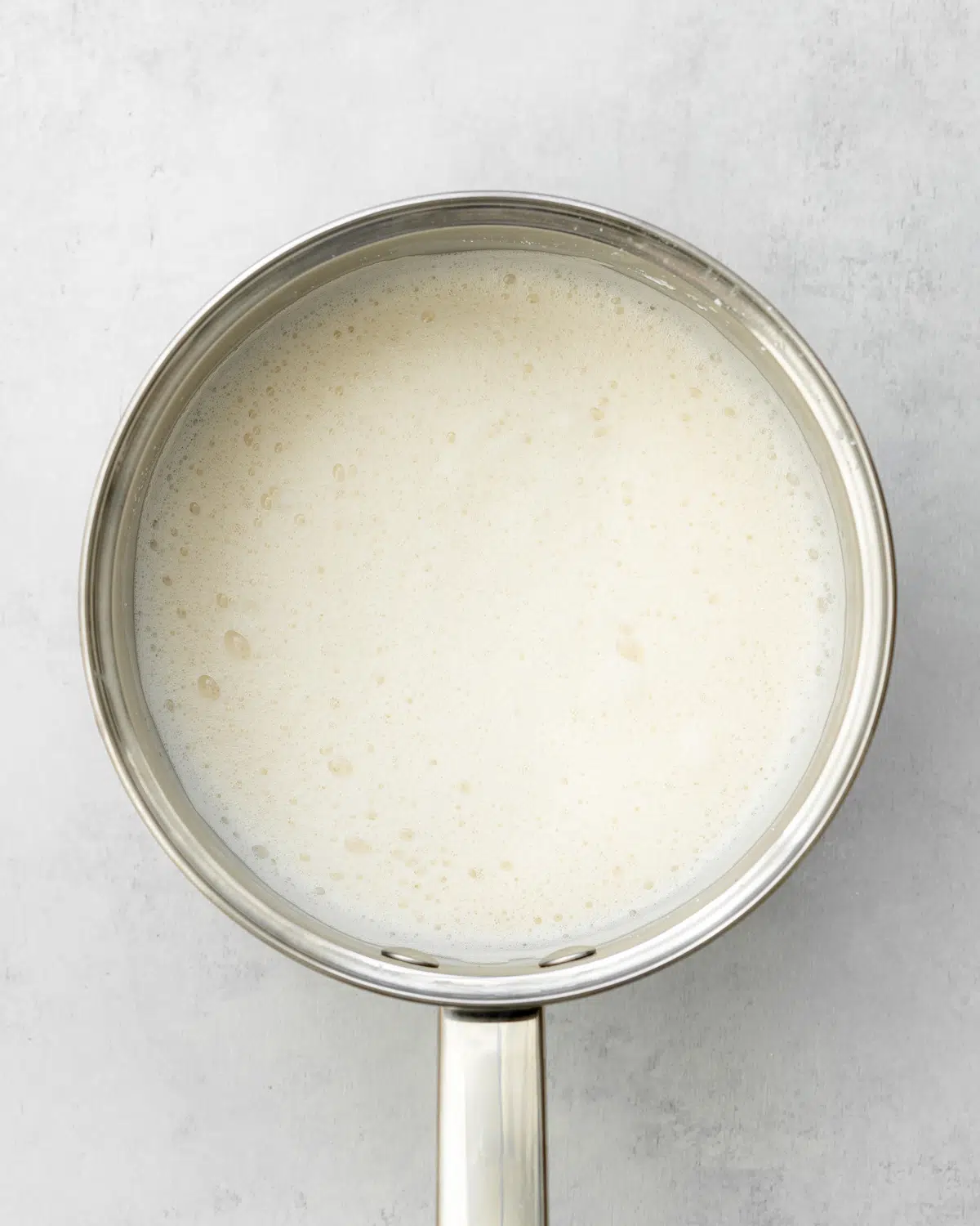 foamy milk in a saucepan.