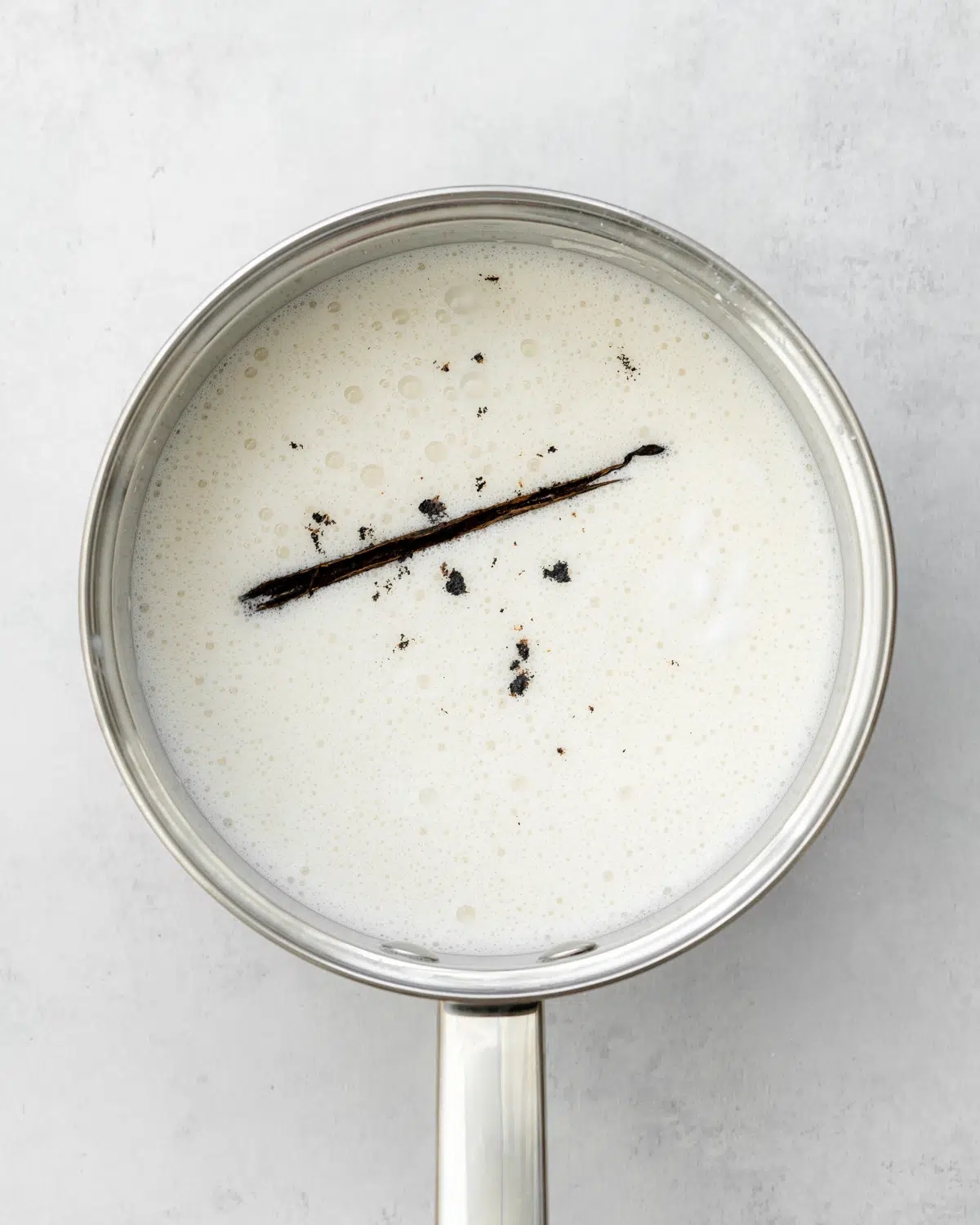 milk and vanilla pod in saucepan.