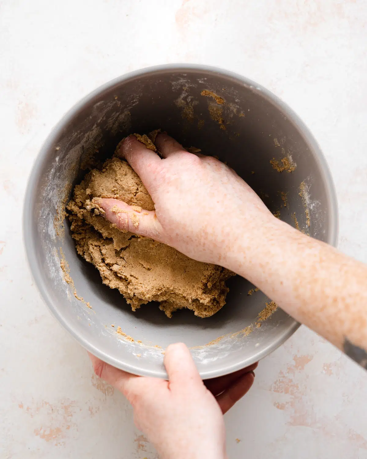 hand kneading cookie dough for biscoff cookies.