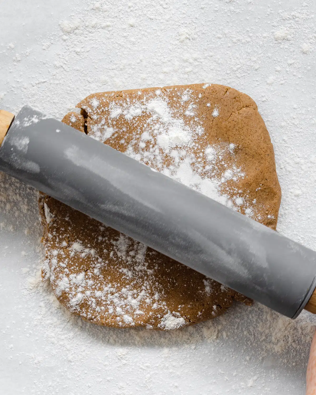 rolling out cookie dough with a rolling pin.