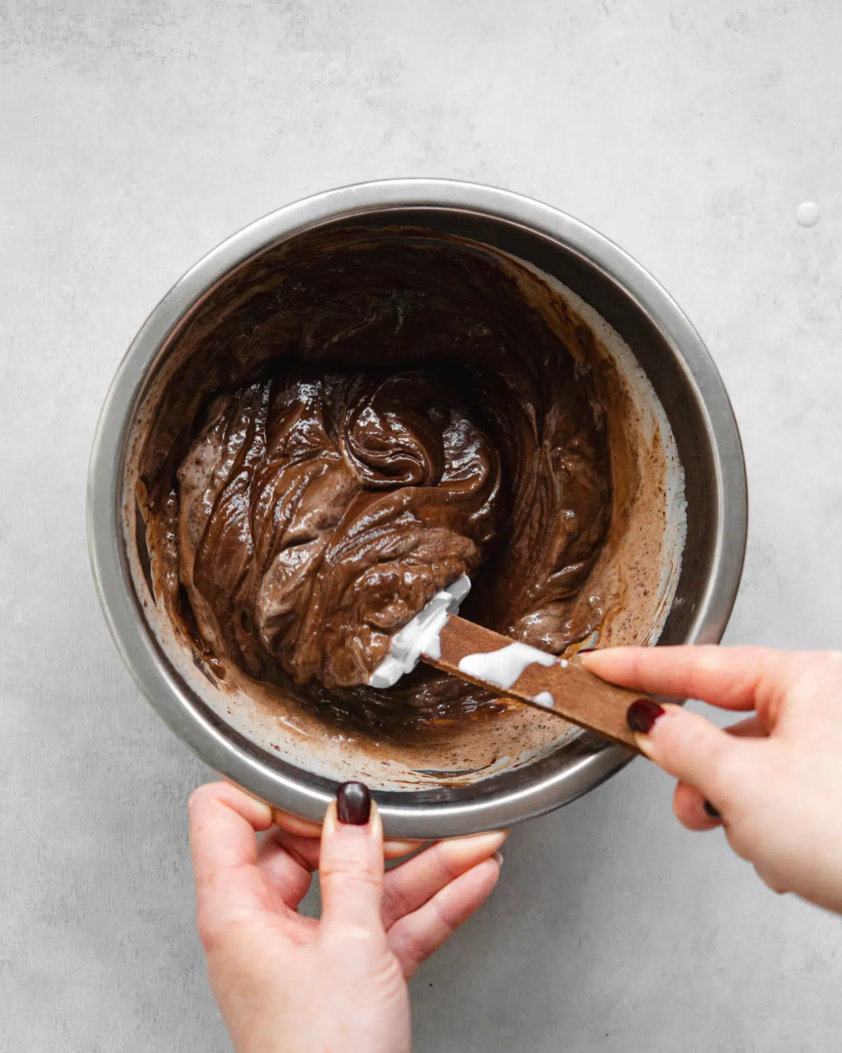 mixing chocolate ganache in a bowl.