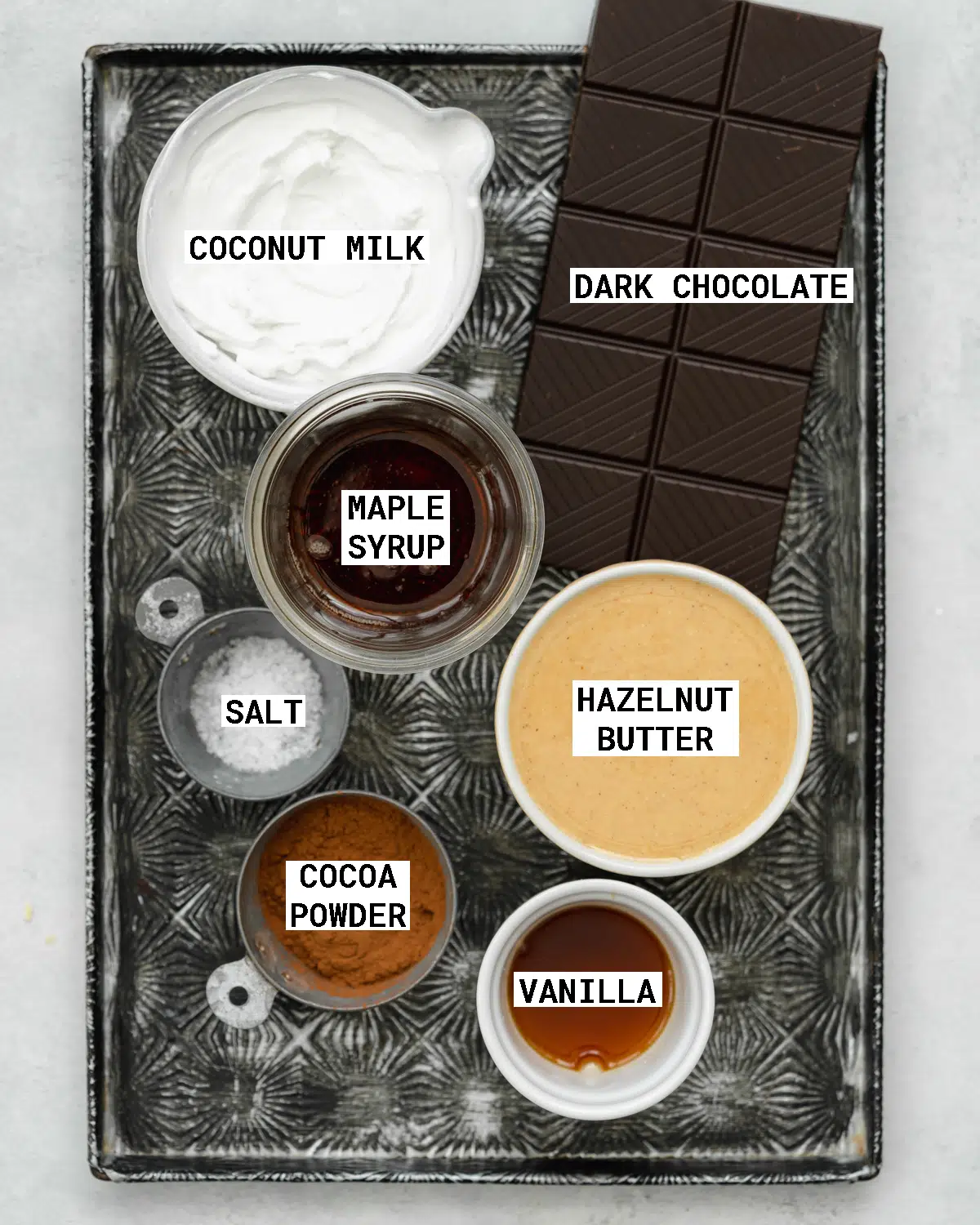 ingredients to make chocolate hazelnut spread on a tray.
