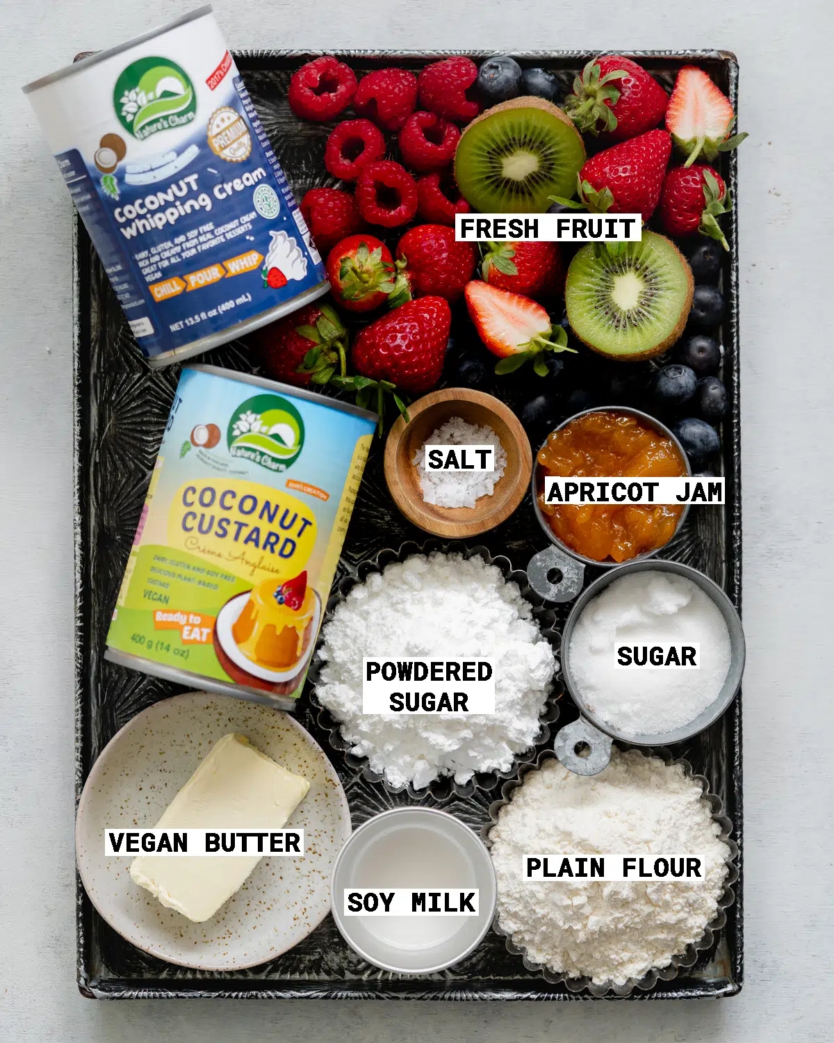 ingredients to make vegan french fruit tart on a vintage metal tray.