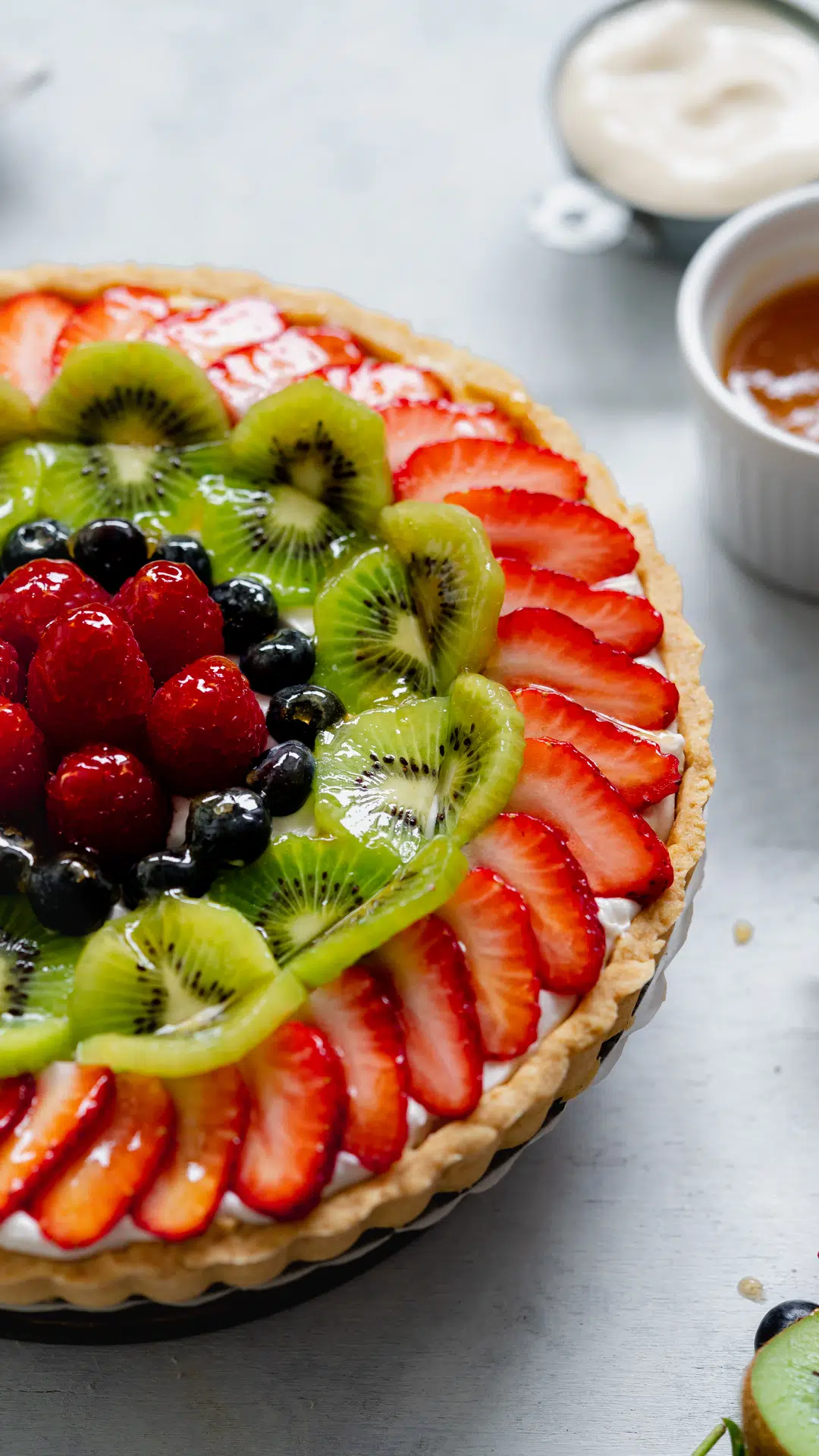 closeup of vegan french fruit tart with fresh fruit on top.