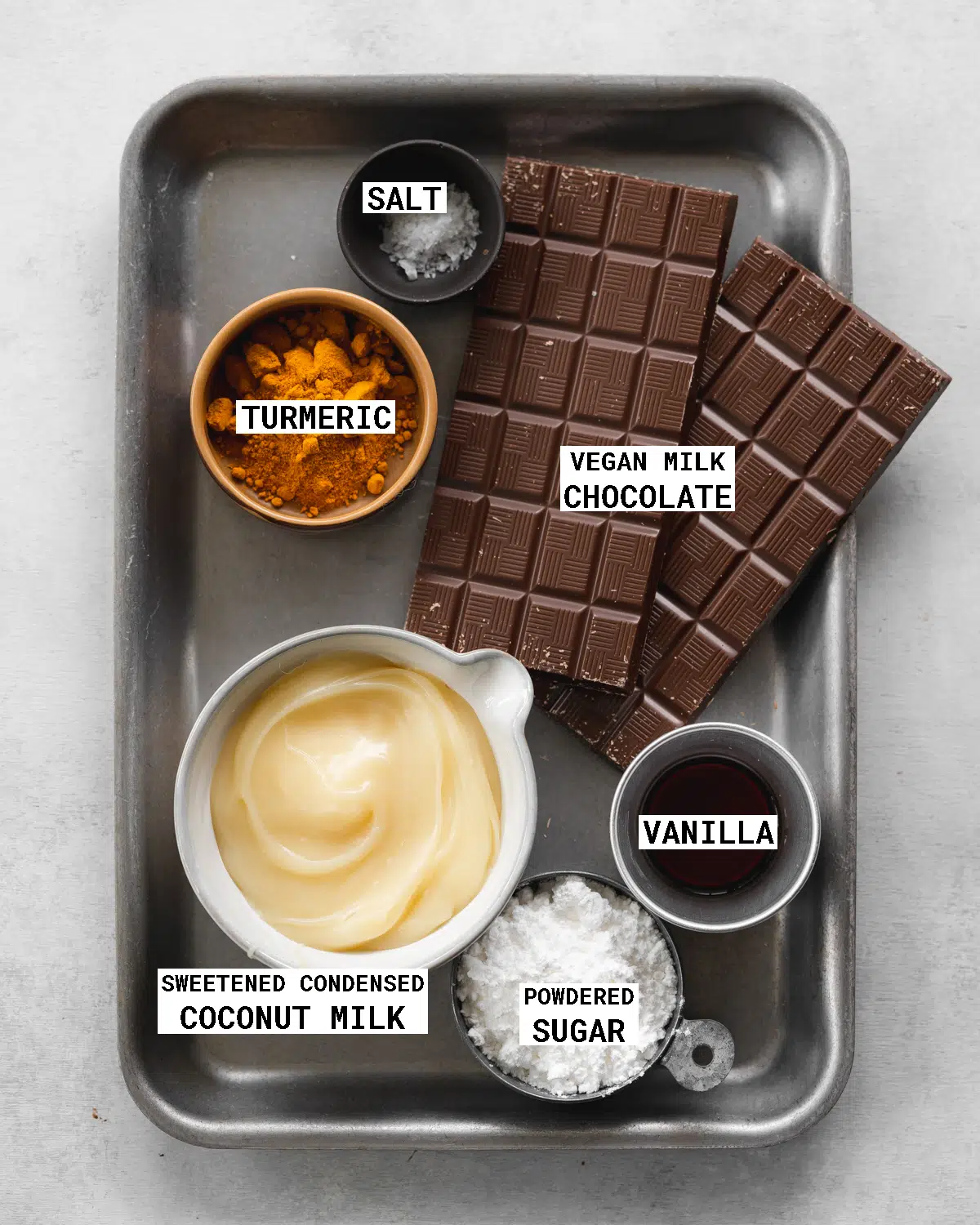 ingredients to make cadburys cream eggs on a metal tray.