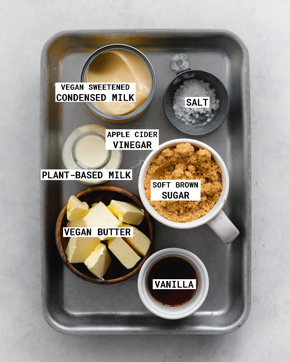 top down view of a tray with the ingredients needed to make vegan caramel sauce.