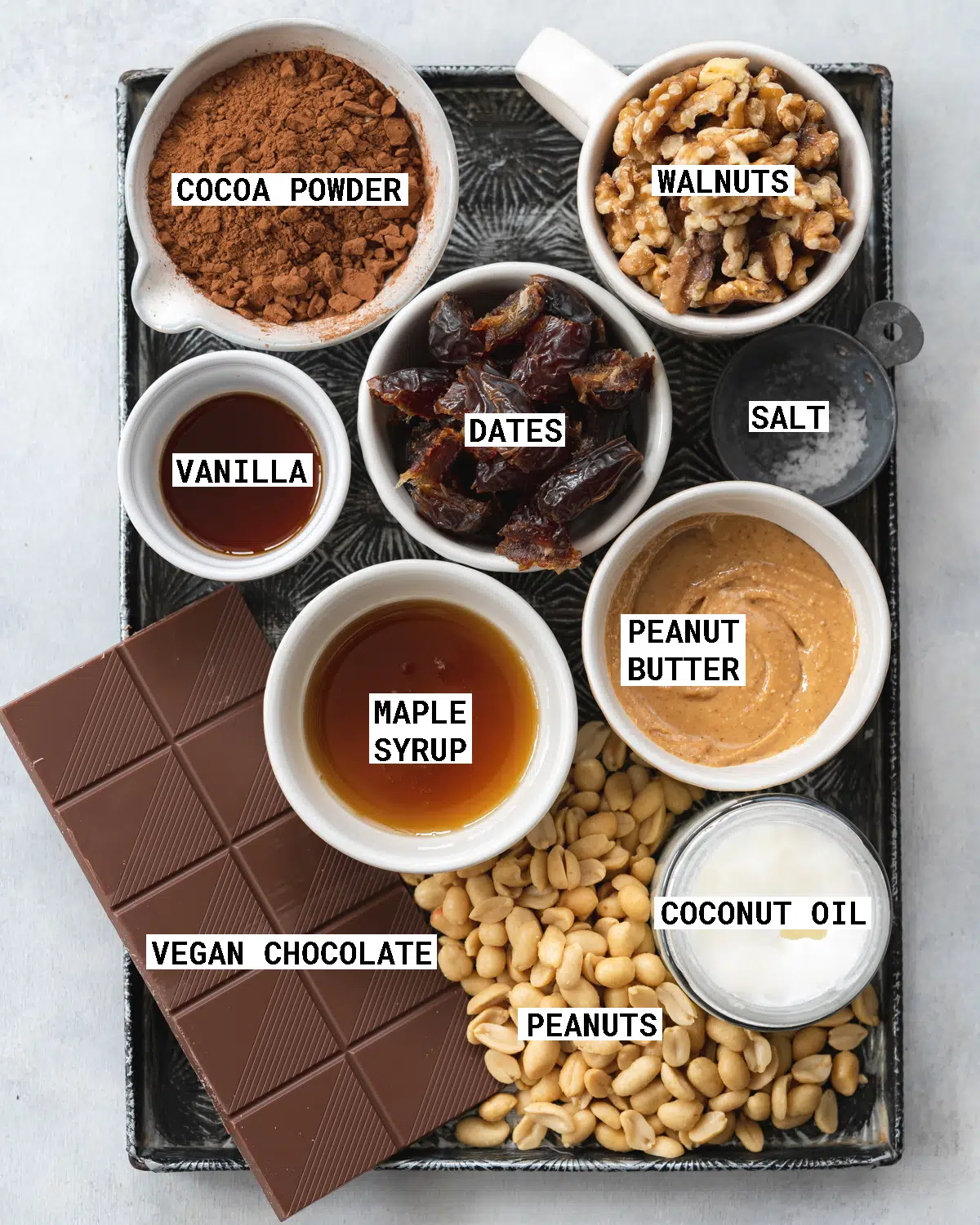 Top down view of ingredients for peanut butter brownies on a vintage metal tray.