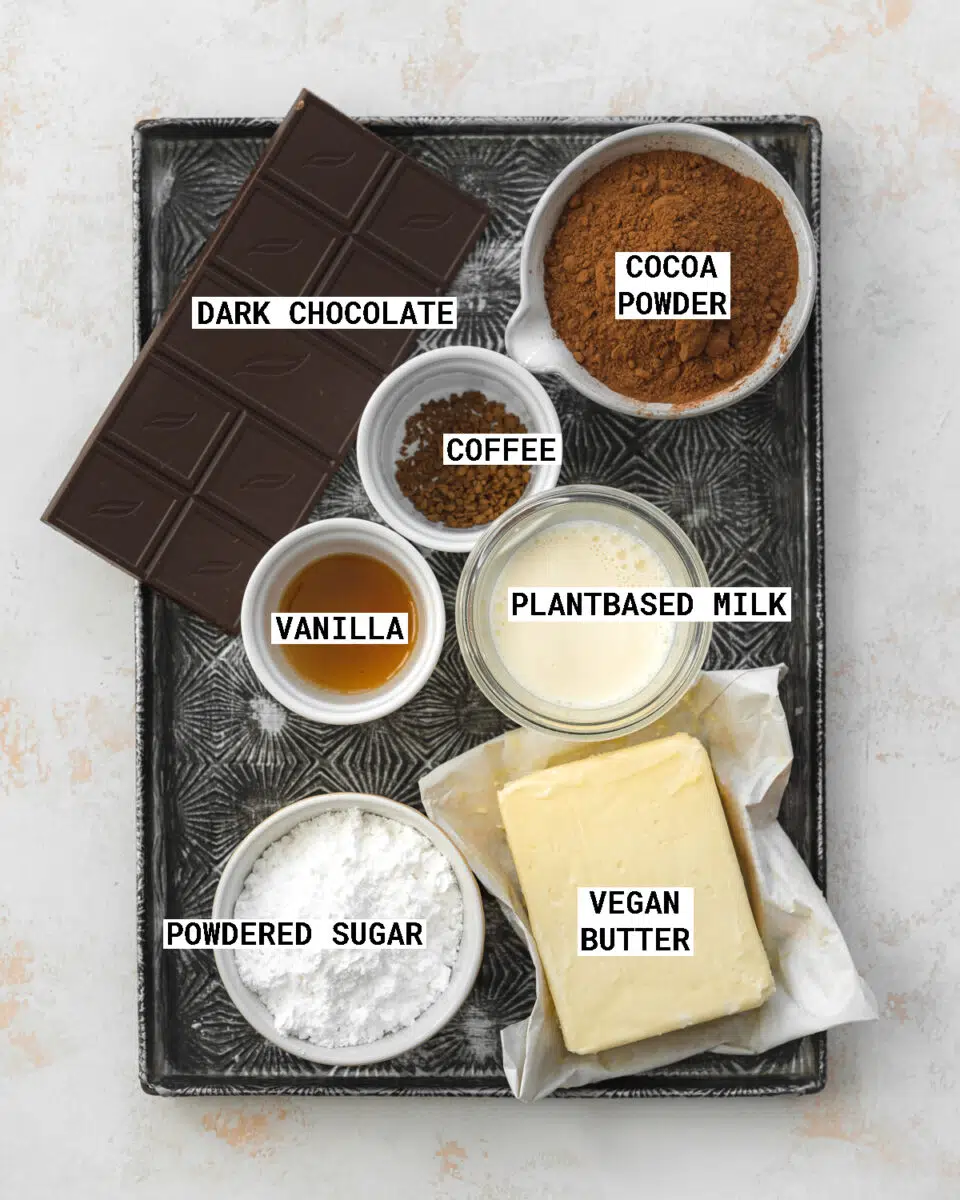 top down view of ingredients to make vegan chocolate buttercream on a vintage tray.