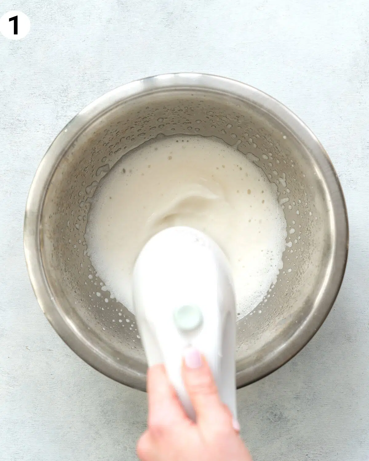 whisking aquafaba with an electric mixer.