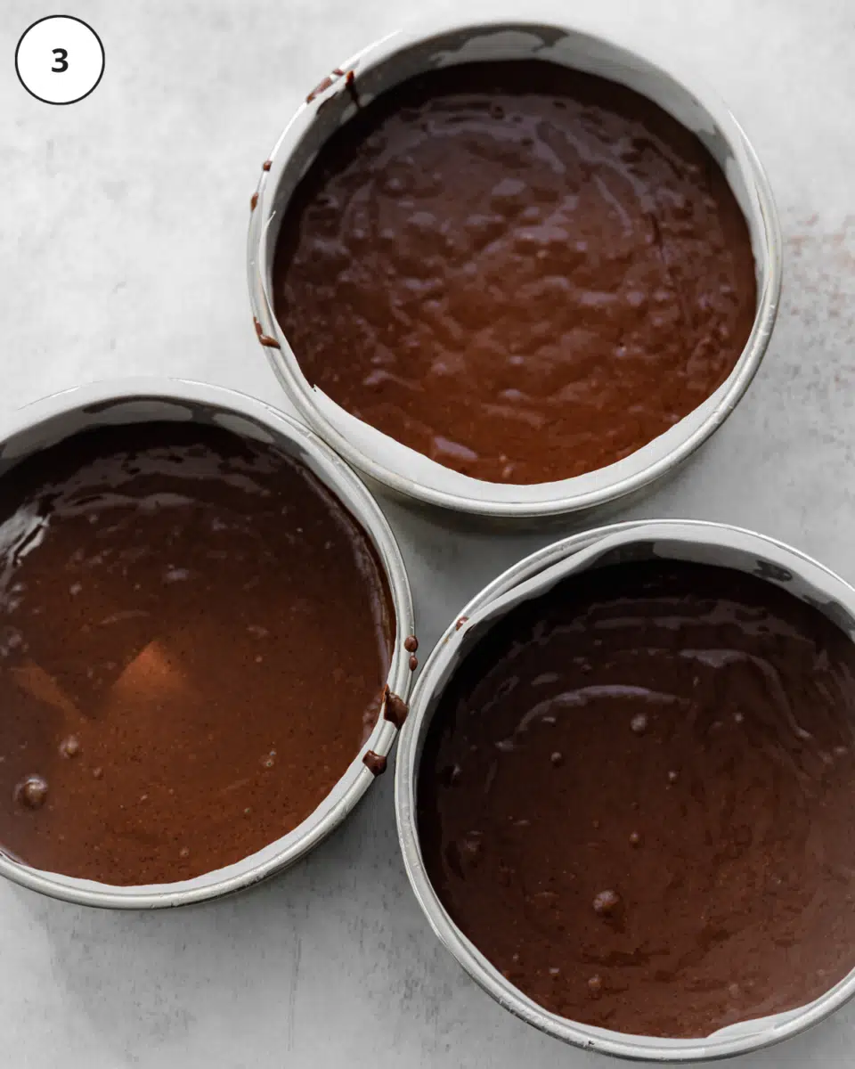 top down view of cake tins filled with chocolate cake batter.