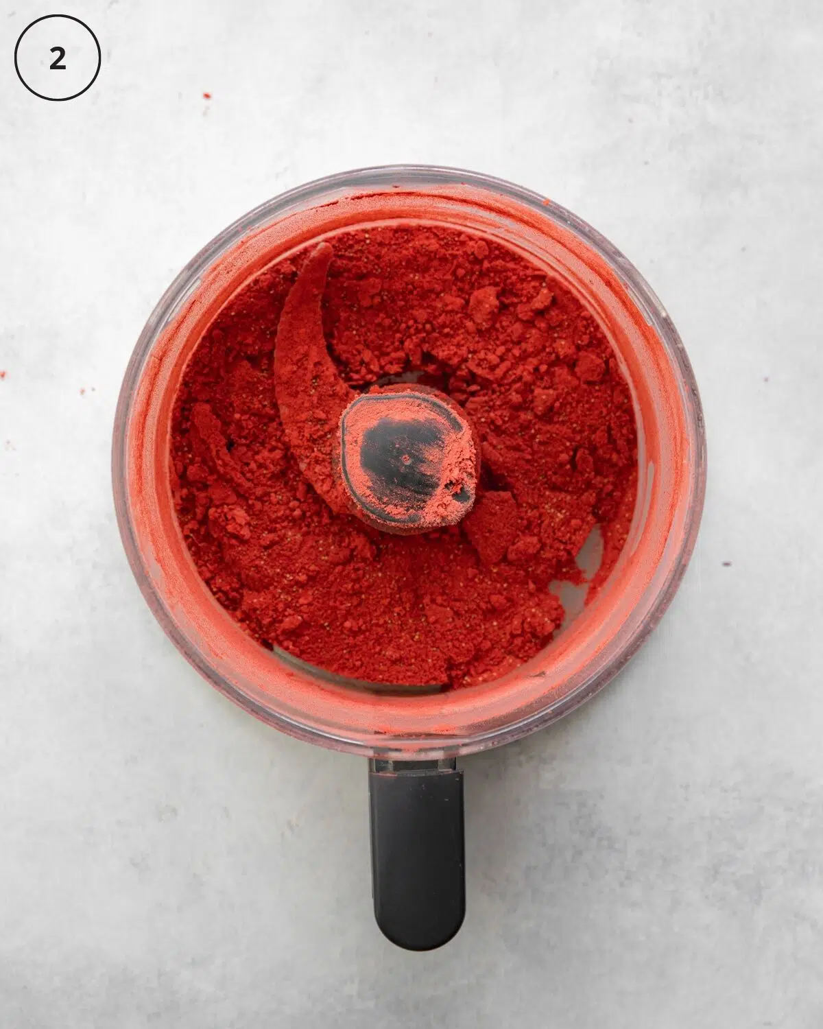 top down view of food processor with freeze dried strawberries.