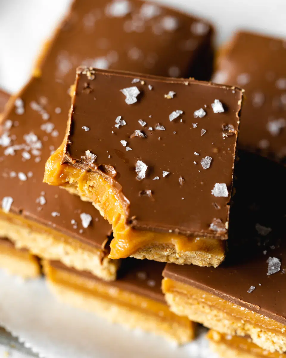 chocolate peanut butter slices with flaky sea salt on top.