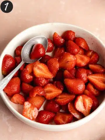 strawberries macerating in a bowl with sugar.