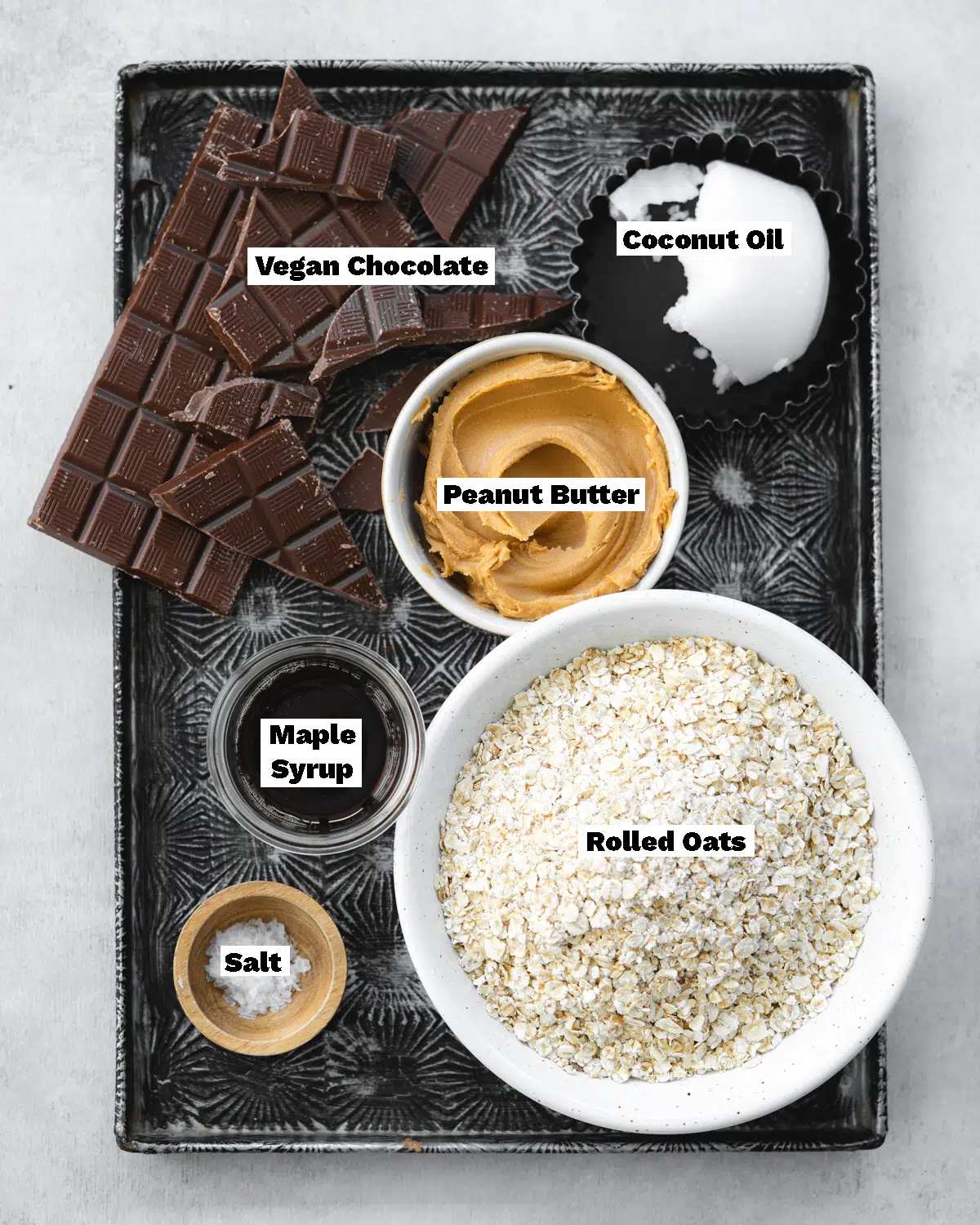 ingredients to make oatmeal peanut butter bars measured out on a metal tray.