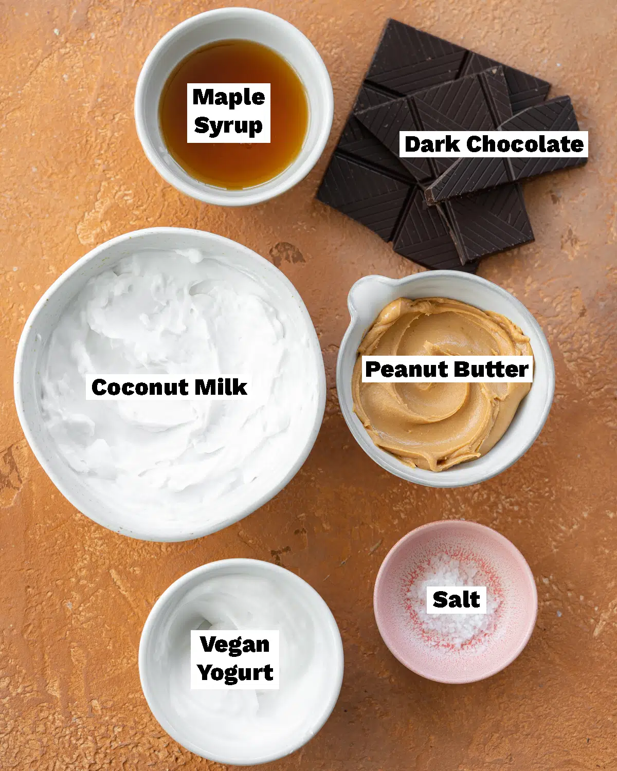 ingredients for vegan magnum ice creams measured out on a coral stone surface.