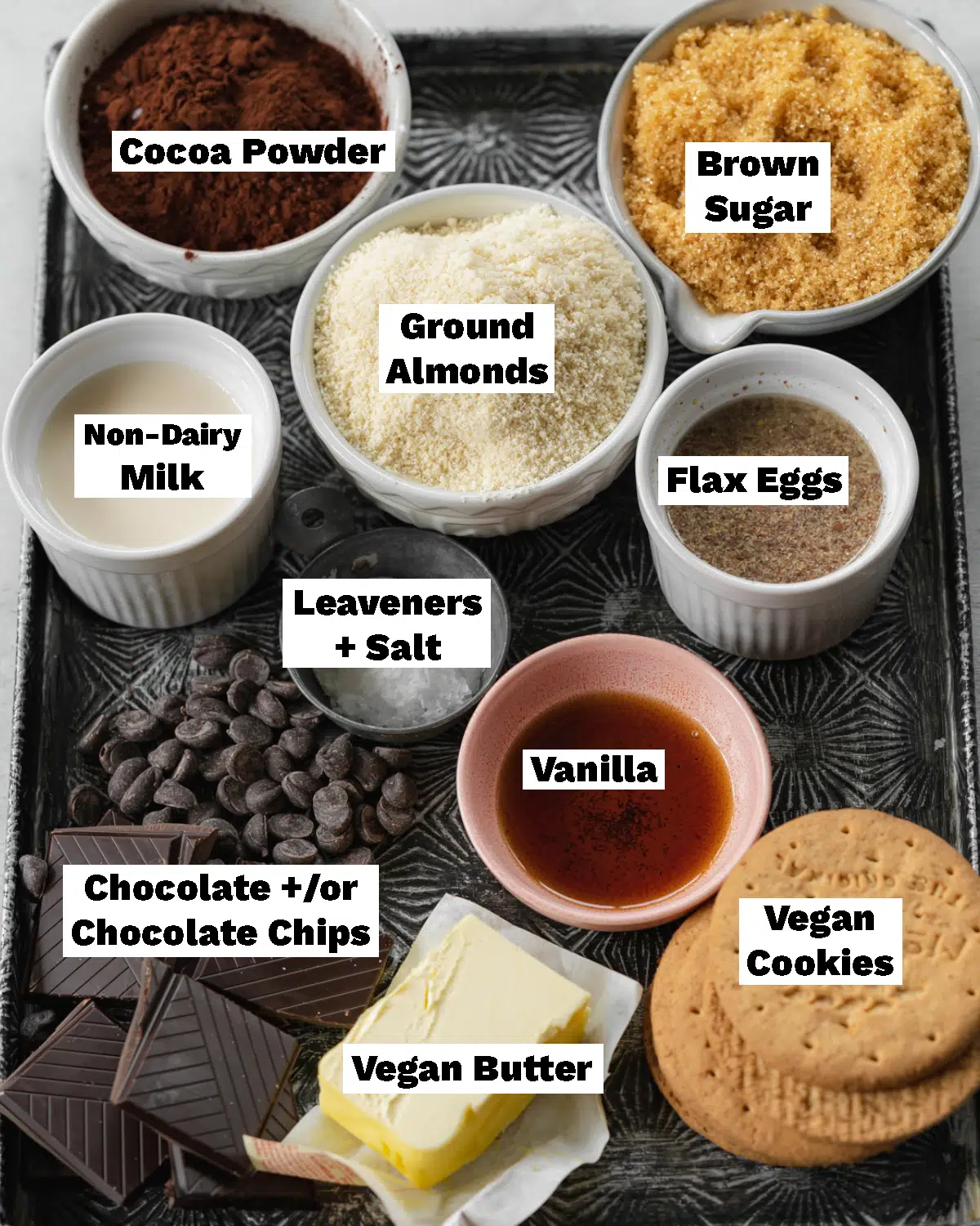 ingredients for smores brownies measured out on a metal tray.