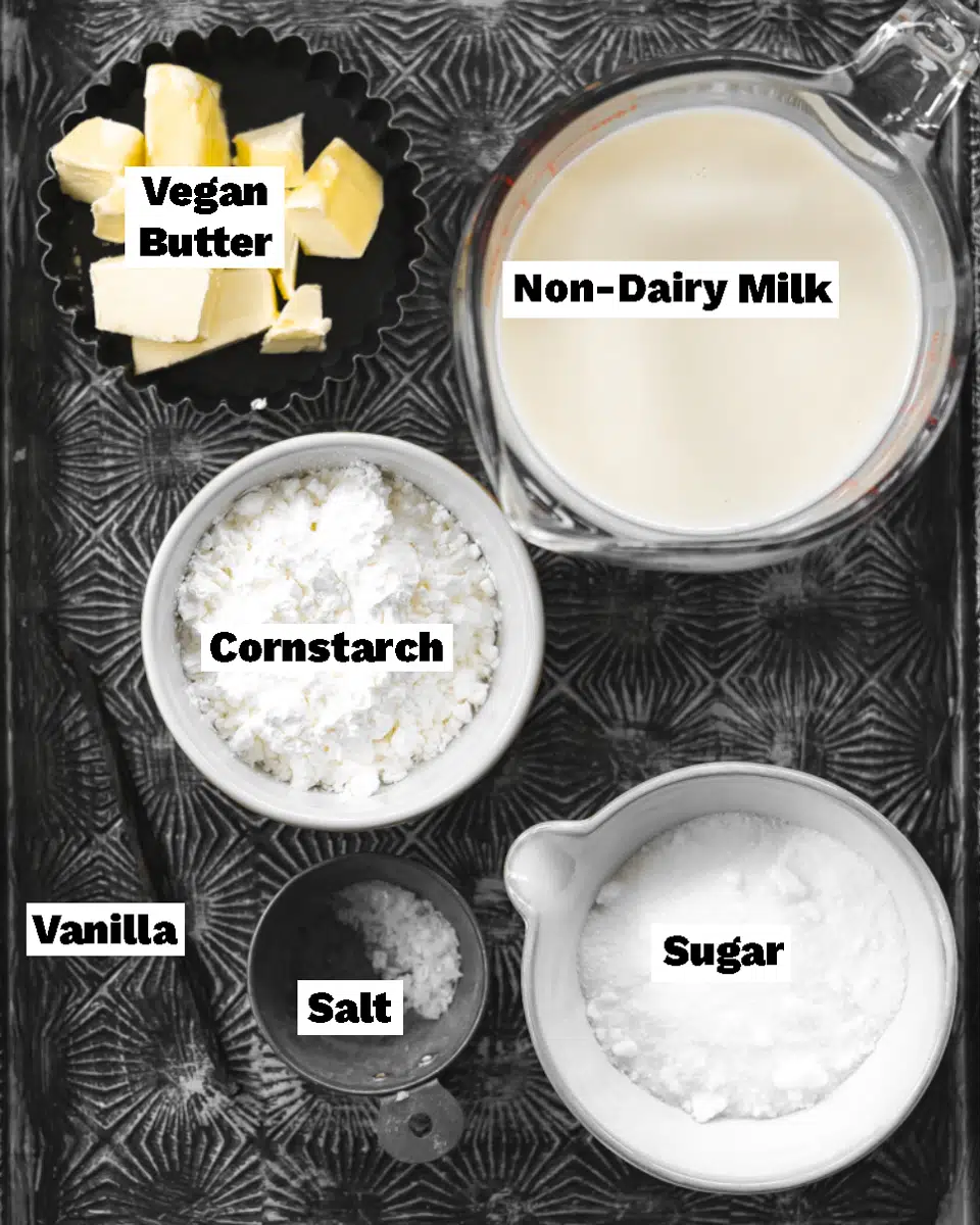 ingredients to make vegan pastry cream measured out on a metal tray.