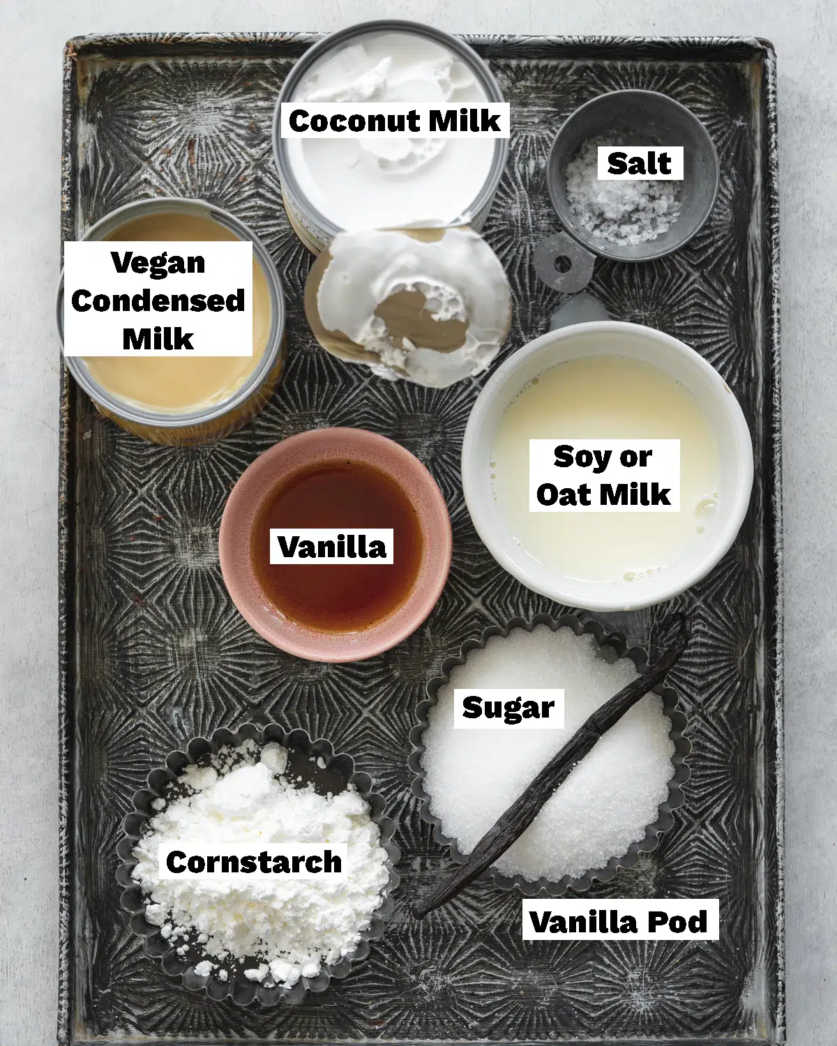 ingredients for dairy-free vanilla ice cream measured out on a metal tray.