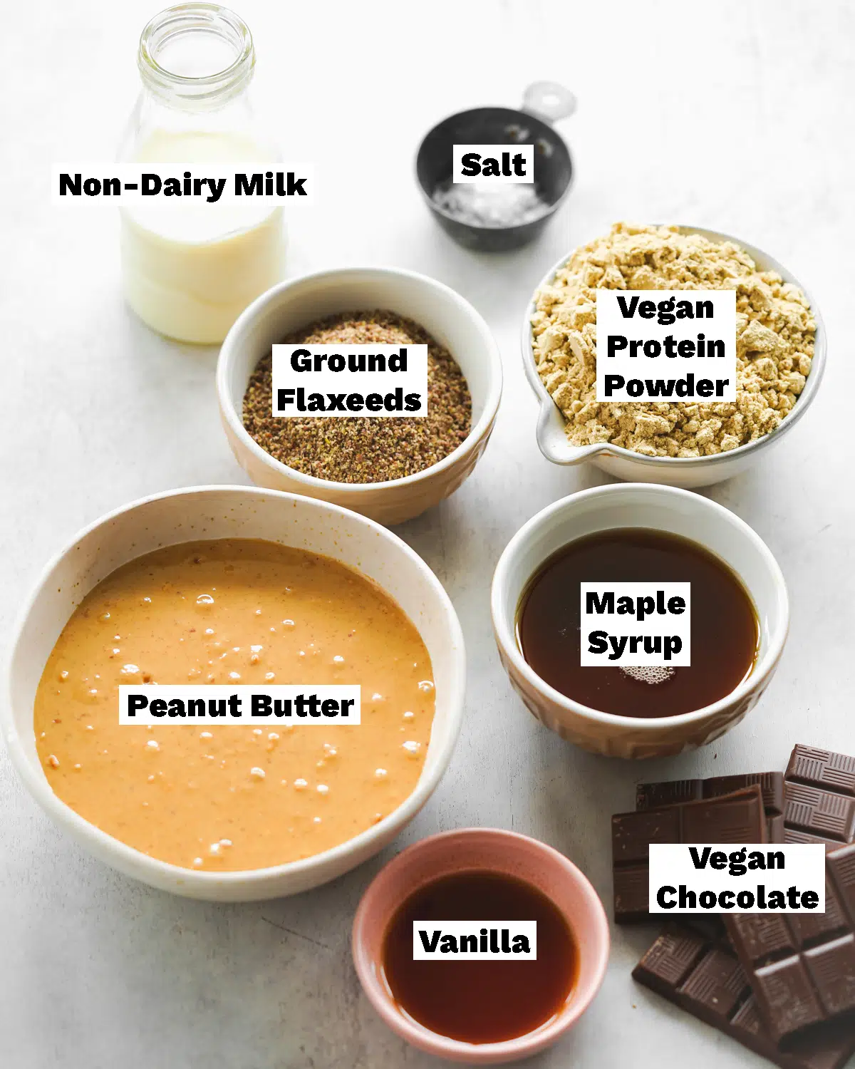 ingredients for vegan protein bars measured out in bowls.