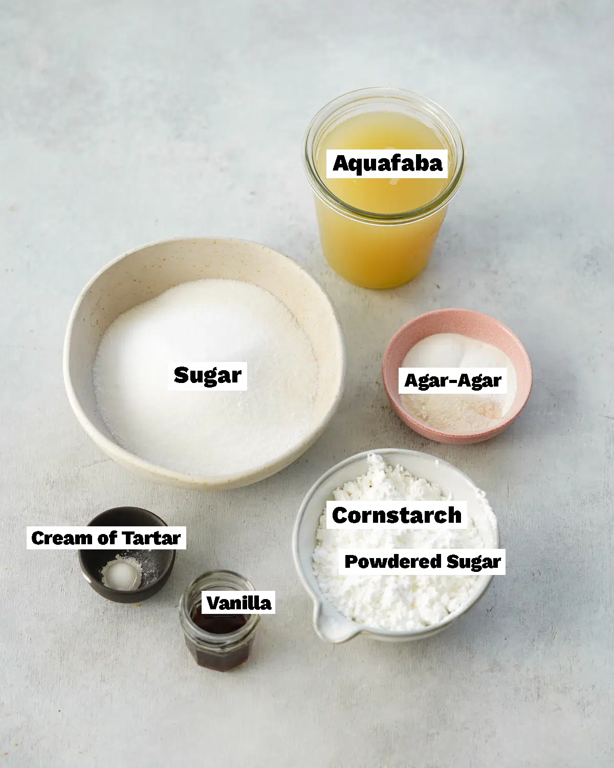 ingredients to make vegetarian marshmallows measured out in bowls and jars.