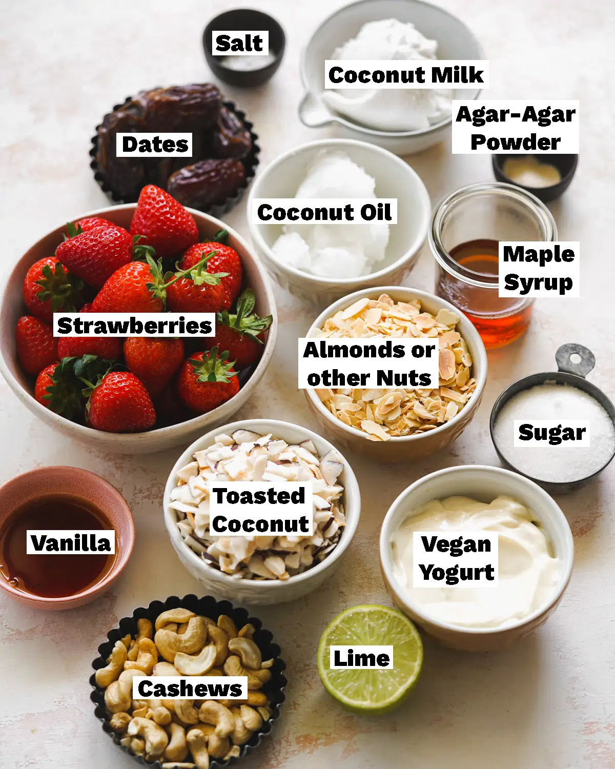 ingredients for vegan strawberry cheesecake bars measured out in bowls.