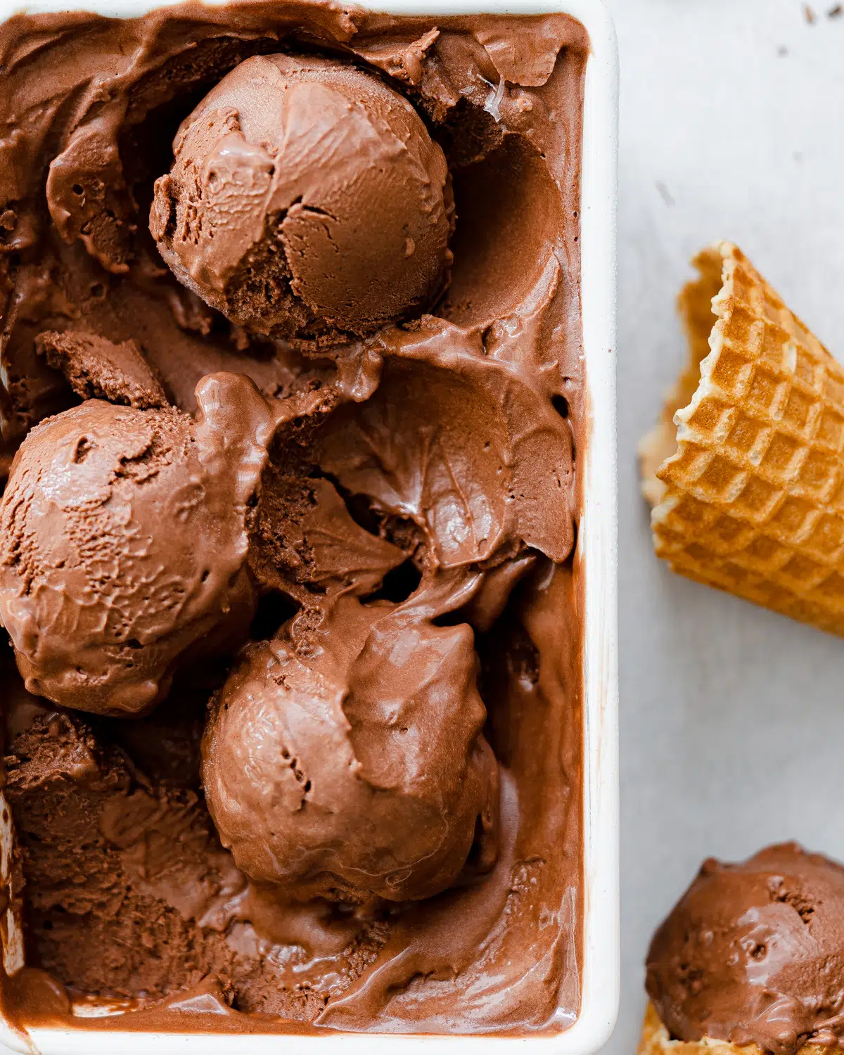 chocolate ice cream in a ceramic tub with ice cream cones.