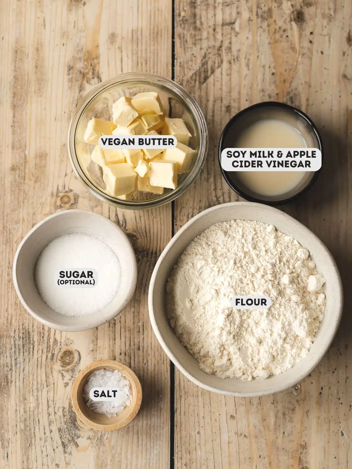 ingredients for vegan pie crust measured out in bowls on a wooden surface with text overlay.