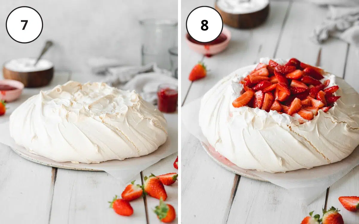pavlova being decorated with coconut cream and fresh strawberries.