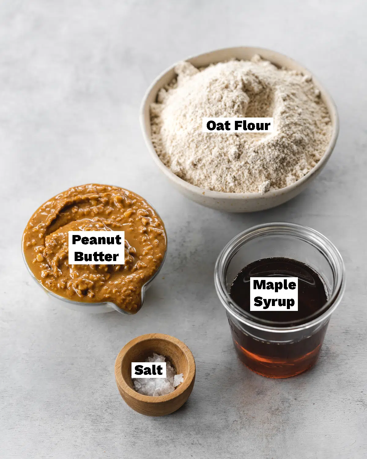 ingredients to make no bake peanut butter cookies measured out in bowls.
