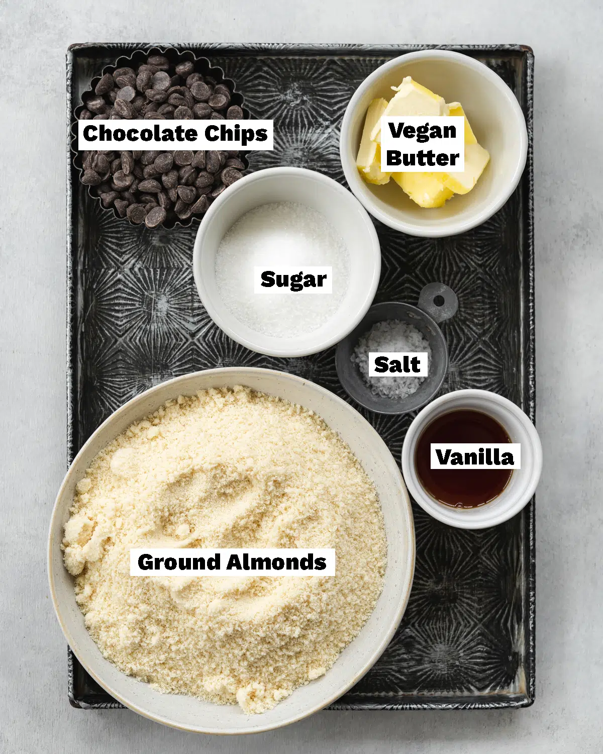 ingredients to make edible cookie dough measured out on a vintage metal tray.